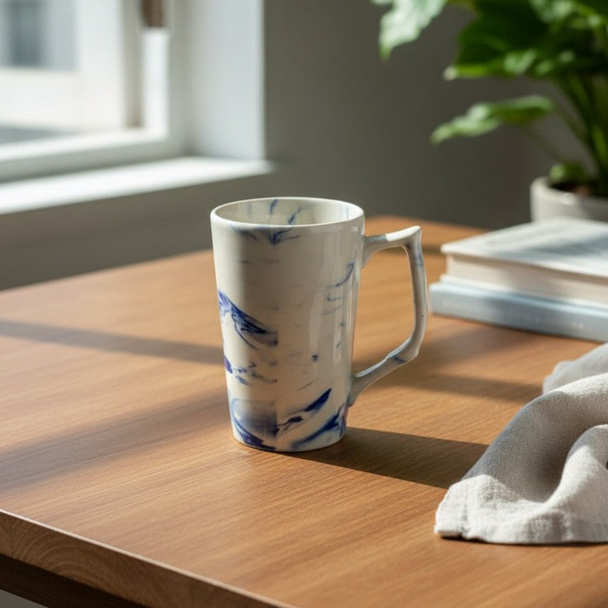 Large artisanal ceramic mug showcasing blue marbled pattern and sturdy handle