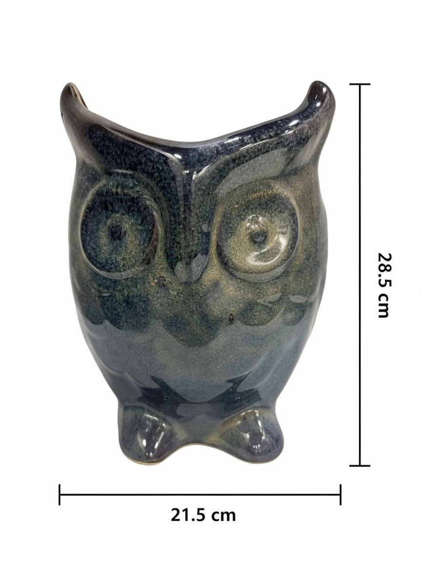 Glossy blue owl-shaped ceramic planter, modern garden décor, suitable for diverse plant arrangements.