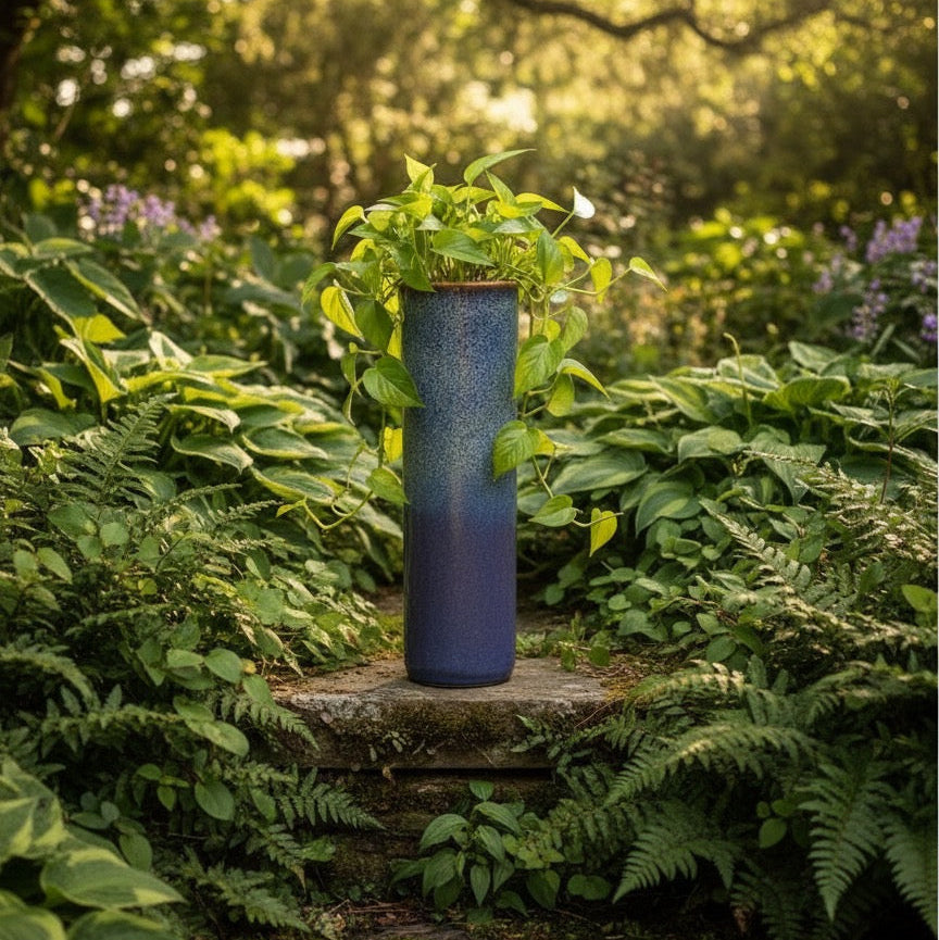 Slim blue purple ceramic planter used as an indoor and outdoor pot for decorative houseplants.