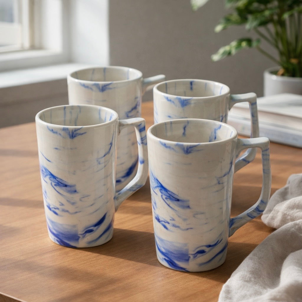 Set of 4 Blue white marbled ceramic coffee mug, side view on table 